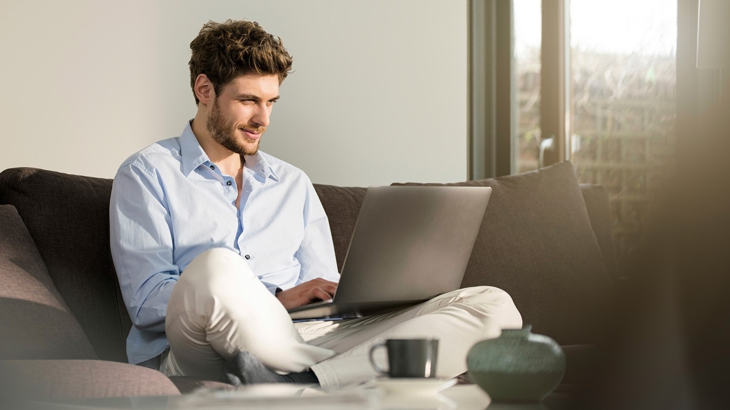 Man booking an online service on laptop